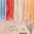 Парти украса за фон- Многоцветна завеса от ленти в синьо, корал, розово и праскова със златни елементи- Emotions Factory